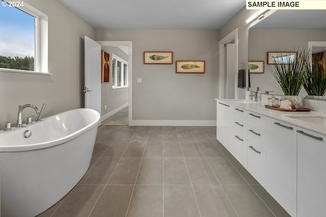 bathroom featuring vanity, tile floors, and a bathing tub