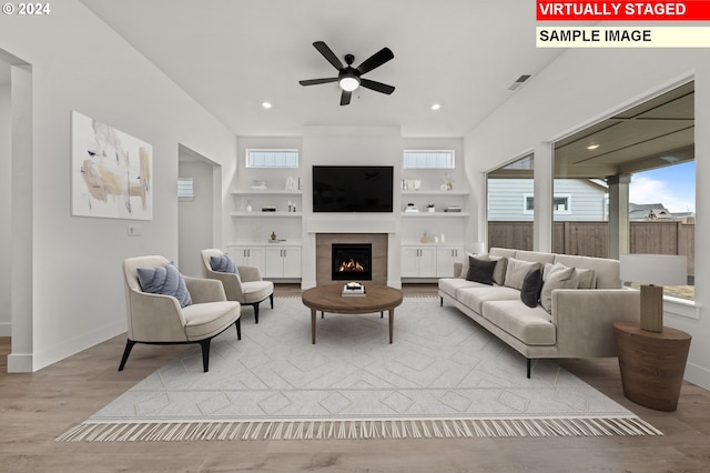 1814 S Maple St, Canby, OR 97013 - living room featuring a ceiling fan, wood finished floors, a fireplace, baseboards, and built in features