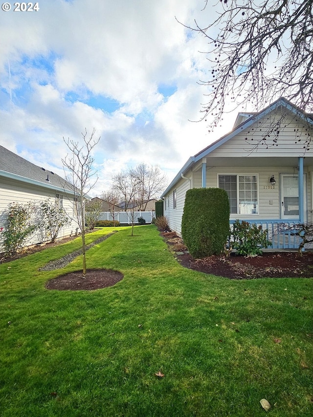 view of yard featuring covered porch