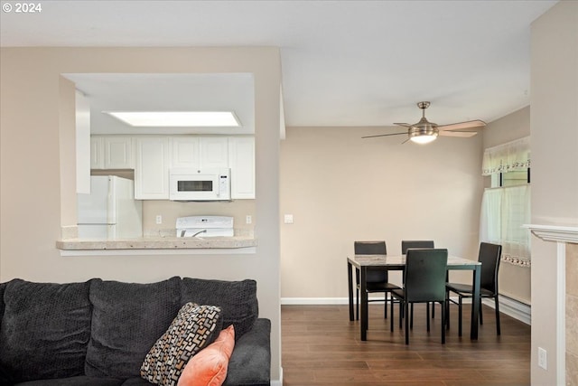 dining area with ceiling fan and dark wood-type flooring