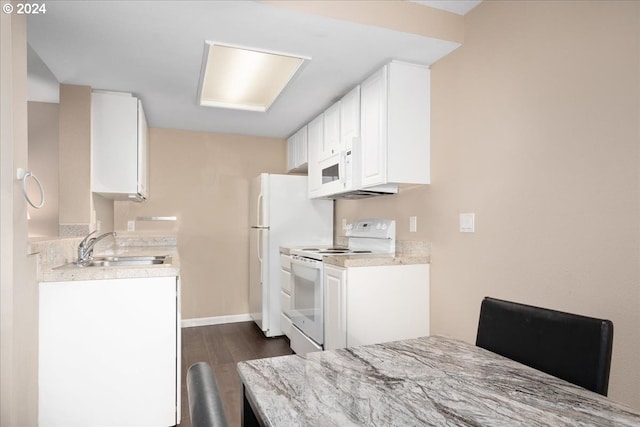 kitchen with white appliances, white cabinetry, dark wood-type flooring, and sink