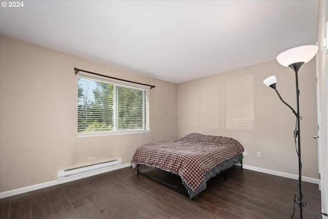 bedroom featuring dark hardwood / wood-style floors and a baseboard heating unit