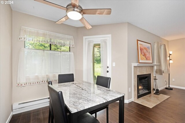 living room with a tiled fireplace and dark hardwood / wood-style flooring