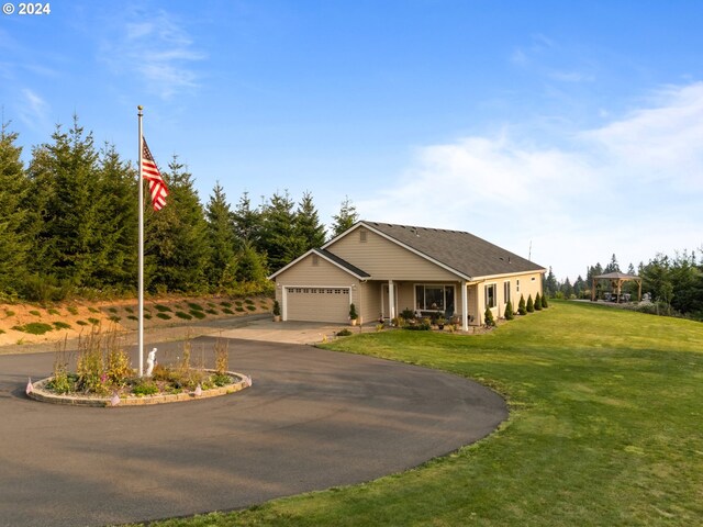 view of front of home featuring a garage and a front lawn