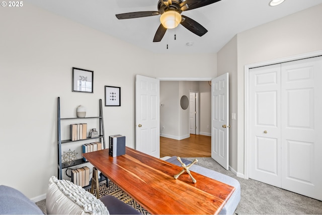 carpeted office with ceiling fan