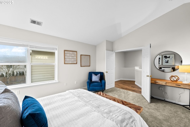 carpeted bedroom featuring vaulted ceiling