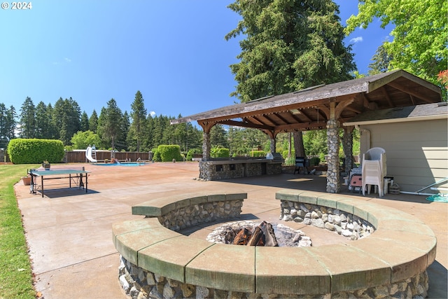 view of patio / terrace featuring a fenced in pool, a gazebo, an outdoor fire pit, fence, and an outdoor bar