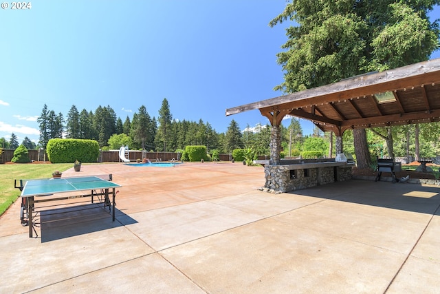 surrounding community with a gazebo, fence, a pool, and a patio