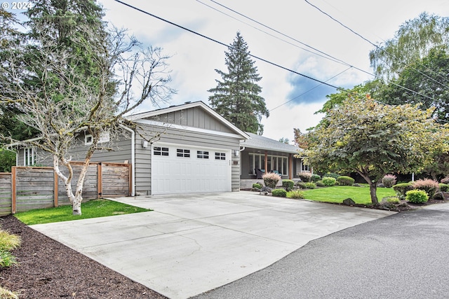 view of front of home with a garage and a front lawn