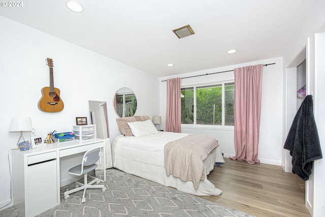 bedroom with hardwood / wood-style flooring