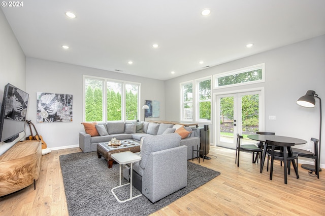 living room with french doors and light hardwood / wood-style flooring