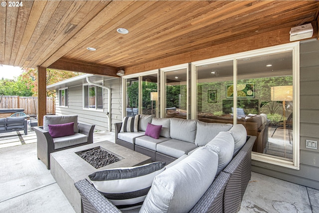 view of patio with an outdoor living space with a fire pit