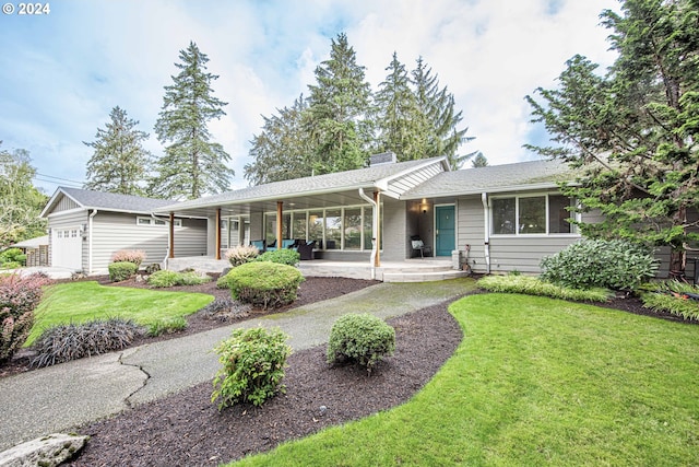 single story home featuring a front lawn and a garage