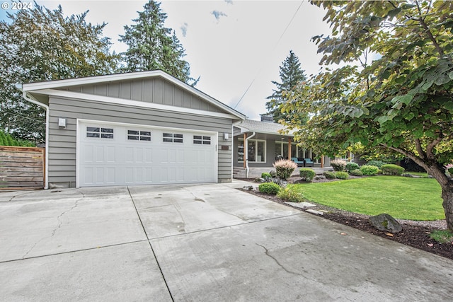 view of front of home featuring a garage and a front lawn