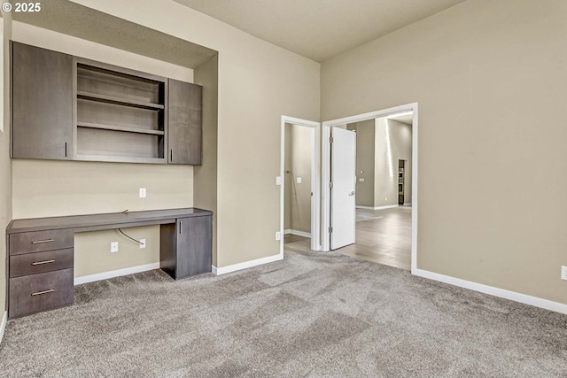 unfurnished office featuring carpet floors and baseboards