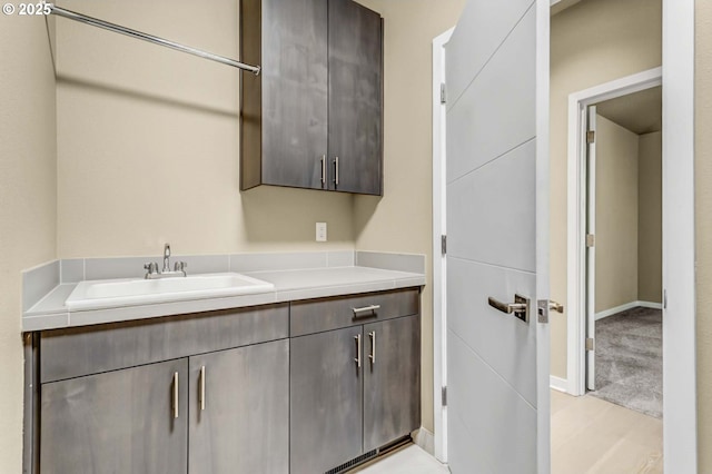 washroom with a sink and light carpet