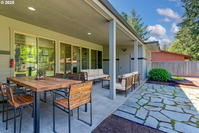 view of patio with outdoor lounge area, fence, and outdoor dining space