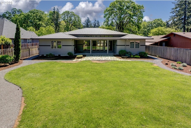 back of property featuring a patio and metal roof