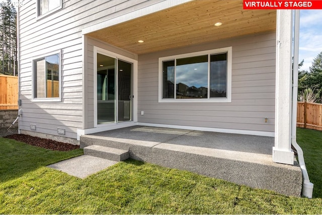 rear view of house featuring a lawn and a patio area