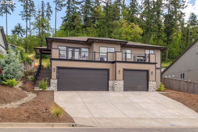 prairie-style house featuring a garage and a balcony