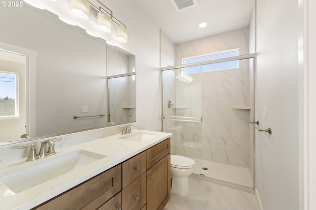 bathroom featuring toilet, visible vents, a sink, and a marble finish shower