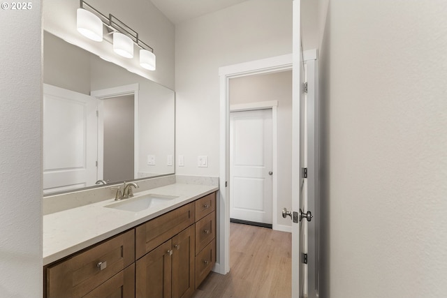 bathroom with wood finished floors and vanity