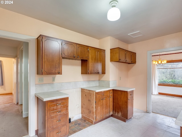 kitchen featuring light carpet and a chandelier