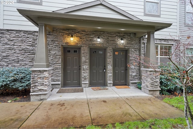 view of exterior entry featuring covered porch