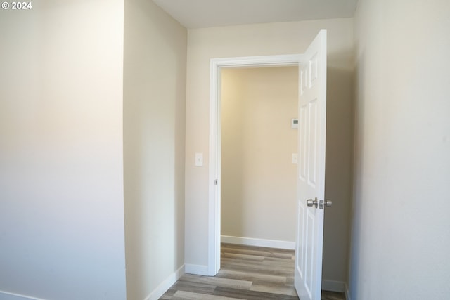 corridor with light hardwood / wood-style floors