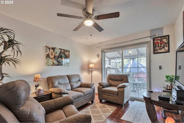 living room featuring a textured ceiling, dark hardwood / wood-style floors, and ceiling fan