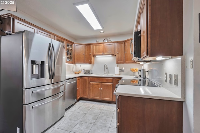 kitchen with sink, light tile patterned floors, and appliances with stainless steel finishes