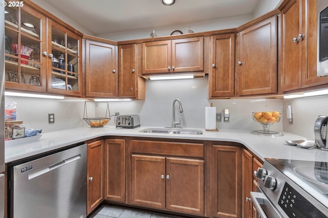 kitchen with light tile patterned floors, sink, and appliances with stainless steel finishes