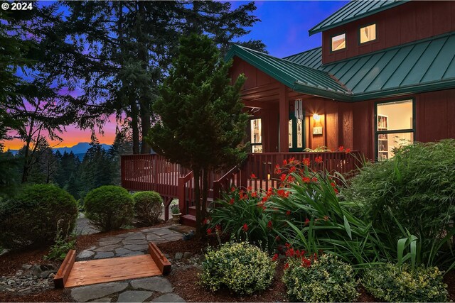 property exterior at dusk with a deck