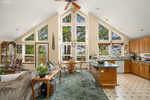 sunroom with ceiling fan, lofted ceiling, and sink