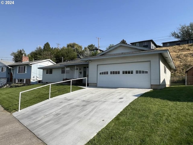 ranch-style home with a garage, concrete driveway, and a front yard