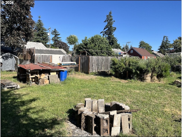 view of yard with a trampoline and a shed