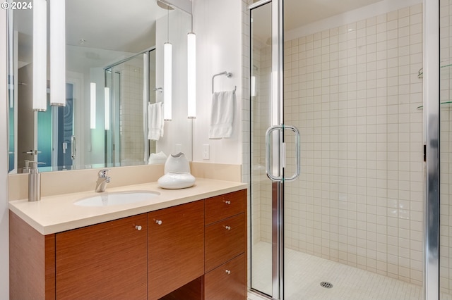 bathroom with a shower with door and oversized vanity