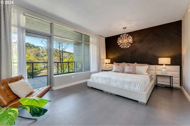 tiled bedroom with an inviting chandelier and access to exterior