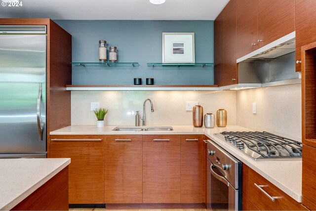 kitchen with built in appliances, a kitchen island, light hardwood / wood-style flooring, a breakfast bar area, and hanging light fixtures