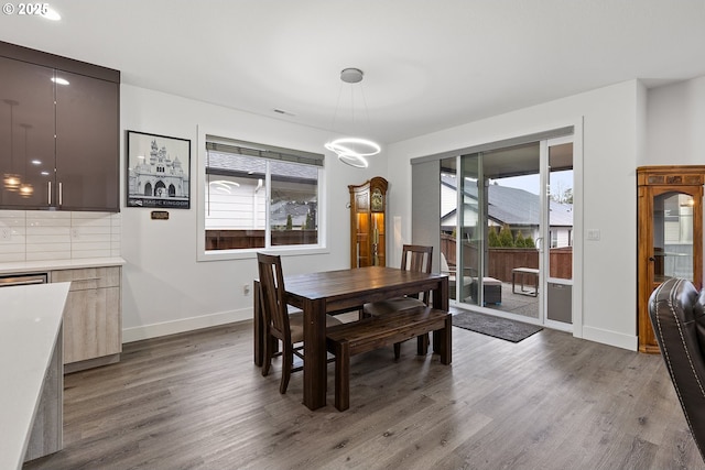 4012 SE 19th Ave, Brush Prairie, WA 98606 - dining room featuring dark wood-style floors, baseboards, and a chandelier