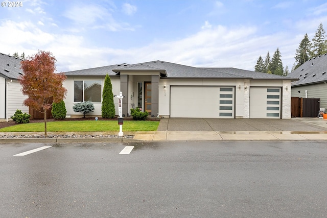 4012 SE 19th Ave, Brush Prairie, WA 98606 - prairie-style house with an attached garage, driveway, stucco siding, a front yard, and roof with shingles