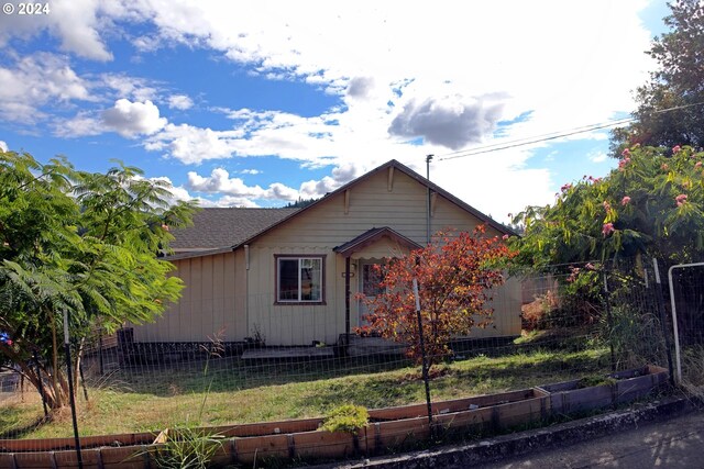 view of side of property with a lawn