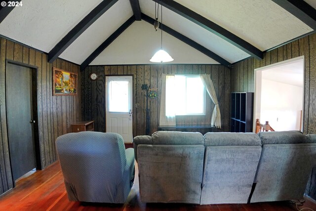 living room featuring vaulted ceiling with beams, wood walls, and dark hardwood / wood-style floors