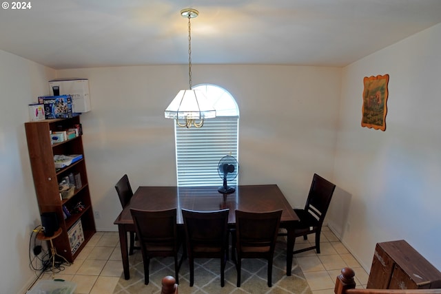 dining room featuring light tile patterned floors and a notable chandelier