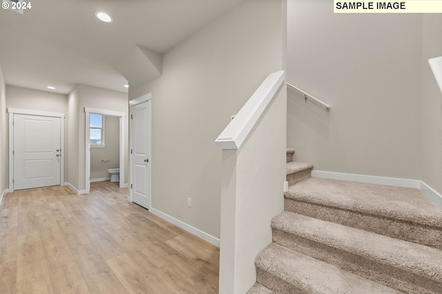 staircase featuring wood-type flooring