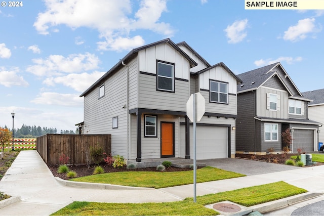 view of front of property with a garage and a front lawn