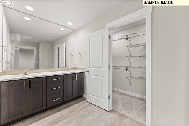 bathroom with vanity and hardwood / wood-style flooring