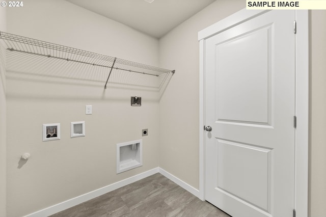 laundry room with hardwood / wood-style flooring, hookup for a washing machine, and hookup for an electric dryer