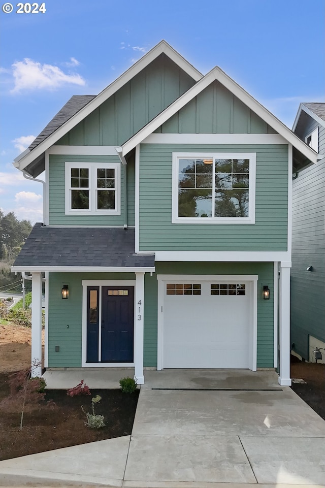 view of front of property with a porch, board and batten siding, a garage, and driveway