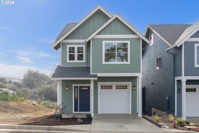 view of front of house featuring a garage, roof with shingles, driveway, and board and batten siding